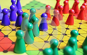 Closeup of gameboard with hexagram, colorful pieces of strategy game sternhalma or chinese checkers
