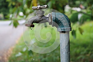 Closeup of a garden tap with dripping water.