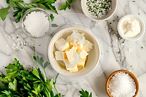 Closeup of garlic creamy butter with salt and greens for sandwiches and steak as background