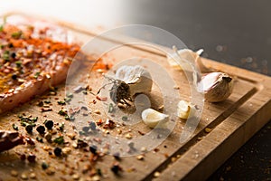 Closeup of garlic with raw fresh pork meat and spices