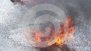 Closeup gasoline puddle on fire, burning liquid, accident, crash