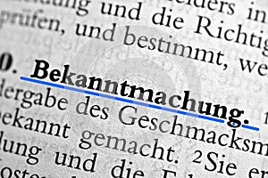 Closeup of the german word Bekanntmachung written in bold font and underlined with blue