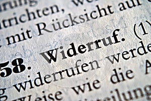 Closeup of the german word Widerruf written in bold font surrounded by blurred words