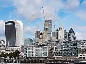 Closeup of the Gherkin between two skyscrapers under construction in the London City