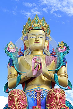 Closeup giant Maitreya Buddha statue with blue sky with clouds.