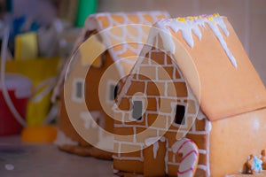 Closeup of gingerbread houses with frosting for Christmas on the table