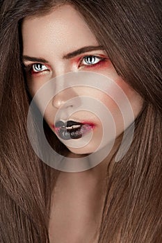 Closeup girl with expresive black and red makeup photo