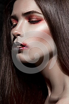 Closeup girl with expresive black and red makeup photo