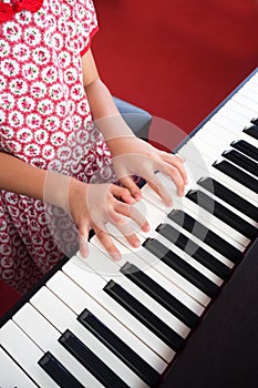 Closeup girl hand playing piano. Favorite music for learning to basic of music and rhythm skill.