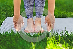 Closeup of a girl`s hands and feet during yoga classes