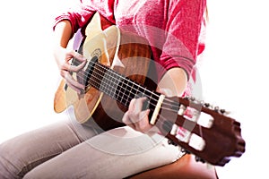 Closeup of girlÃÂ´s hands playing acoustic quitar photo