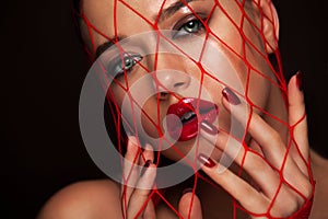 Closeup glamour, fashion portrait of beautiful woman with stockings mesh on face. Wet, glow make up.