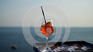 Closeup of glass with Aperol Spritz (aperitif cocktail consisting of prosecco, Aperol and soda water) on