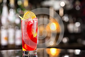 Closeup glass of cocktail with strawberry syrup, rum and lemon d