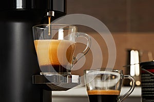 Closeup of a glass cup with fresh coffee from a capsule coffee machine