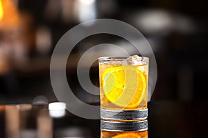 Closeup glass of godfather cocktail with slice of orange