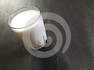 Closeup of a glass of milk, blackbackground photo