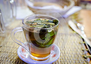 Closeup of a glass of Moroccan mint tea placed on the dining table