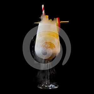 Closeup of a glass of refreshing cocktail drink on a black background