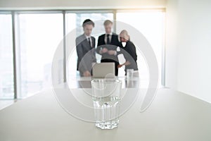 Closeup of a glass of water on office desk