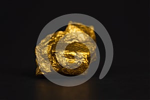 Closeup of gold nugget or gold ore on black background, precious