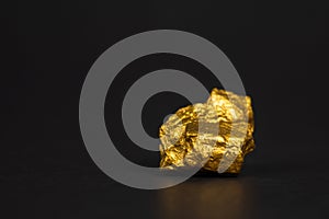 Closeup of gold nugget or gold ore on black background, precious