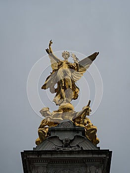 Closeup of golden angel sculpture statue Queen Victoria memorial monument The Mall Buckingham Palace London England UK