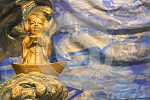 Closeup on golden sculpture of Japanese fishermen god Ebisu Sukunabikona-no-mikoto in Kanda Myojin.