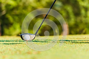 Closeup of golf ball on tee off and driver