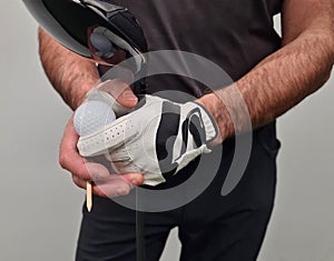 Closeup of golf club driver and ball off tee
