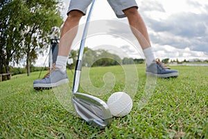 Closeup golfer preparing to hit golfball