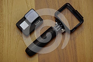 Closeup of Gopro 7 black assorted accessories on wooden background with copyspace