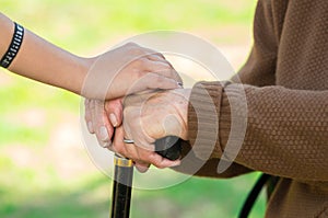 Closeup grandmother granddaughter holding hands