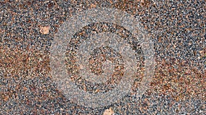 Surface of a granite stone. Brown, white and black texture of a polished natural crystalline rock