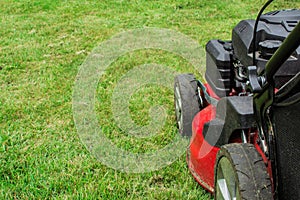 Closeup of grassmower mowing the grass