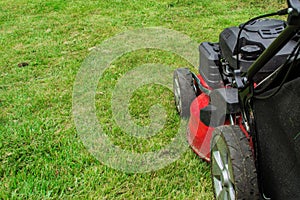 Closeup of grassmower mowing the grass