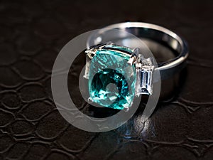 Closeup green gem ring with white diamond