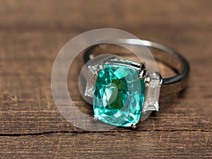 Closeup green gem ring with white diamond