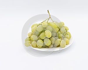 Closeup of green grapes in a plate isolated on a white background
