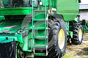 Closeup of green harvester. Parked combain in the spring. Capture agrar technology.