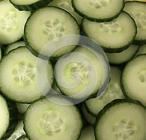 Closeup green sliced cucumber salad background