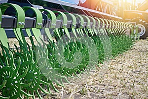 Closeup of a green spoked harrow for cultivating land