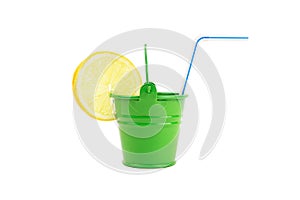 Closeup of a green water bucket with a lemon slice and a drinking straw isolated on white.