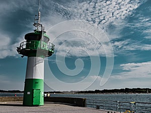 Closeup of the green and white lighthouse in Lubeck, Travemunde, Germany