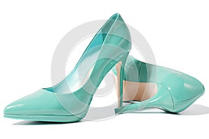 Closeup green women patent leather shoes isolated on white background. Stilettos shoe type. Summer fashion and shopping concept.
