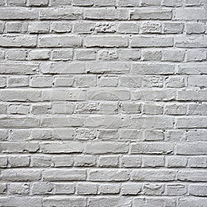Grey painted square part of brick wall
