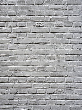 Grey painted square part of brick wall