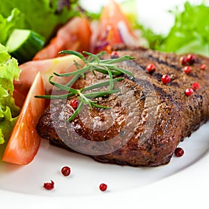 Closeup of grilled steak with vegetables