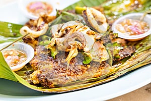 Closeup of grilled stingray fish fillet with spices, popular Malaysia delicacy