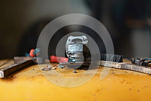 Closeup the grinder and a hammer, wire brush, tool kit for repair